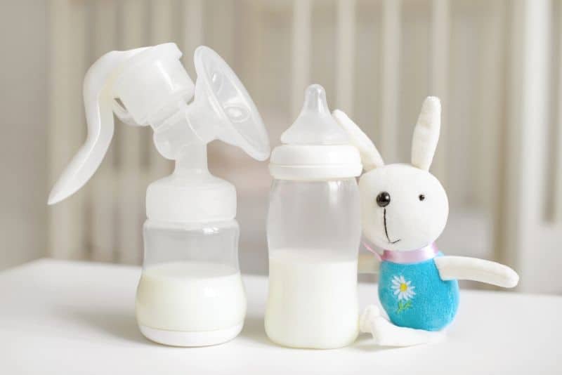 Breast pump and baby bottle on the table