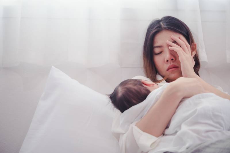 Tired Mother Suffering from postnatal depression 