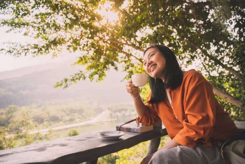 woman drinking coffee in morning with sunshine
