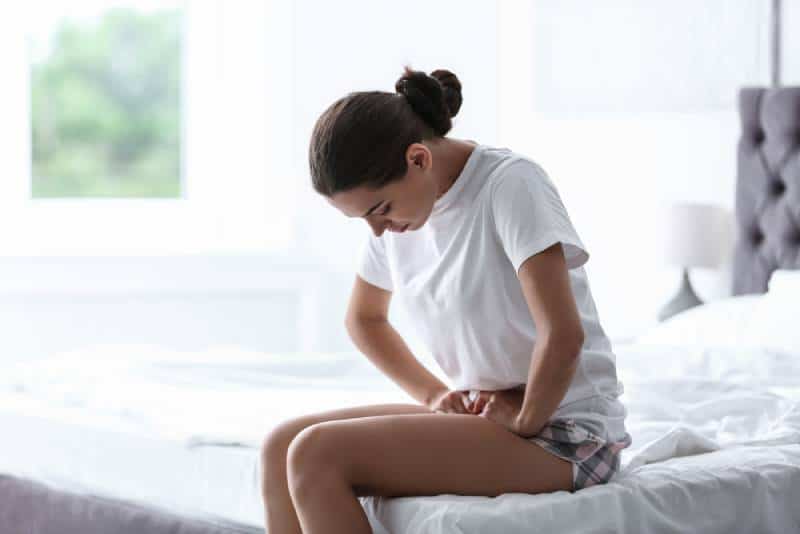 woman suffering from stomach cramps 