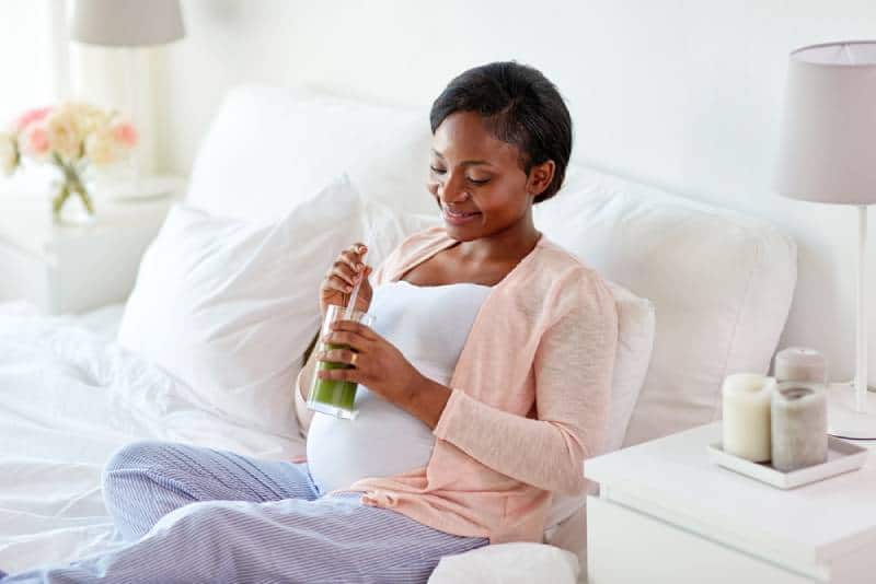 Pregnant woman drinking a healthy smoothie