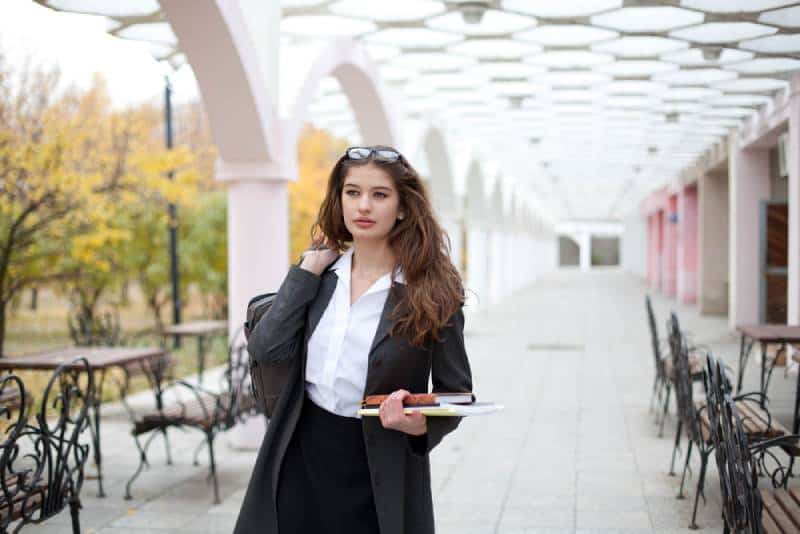 woman going to work carrying a bag and papers