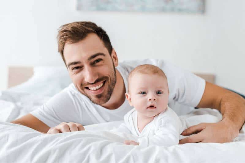 Dad with his baby on bed