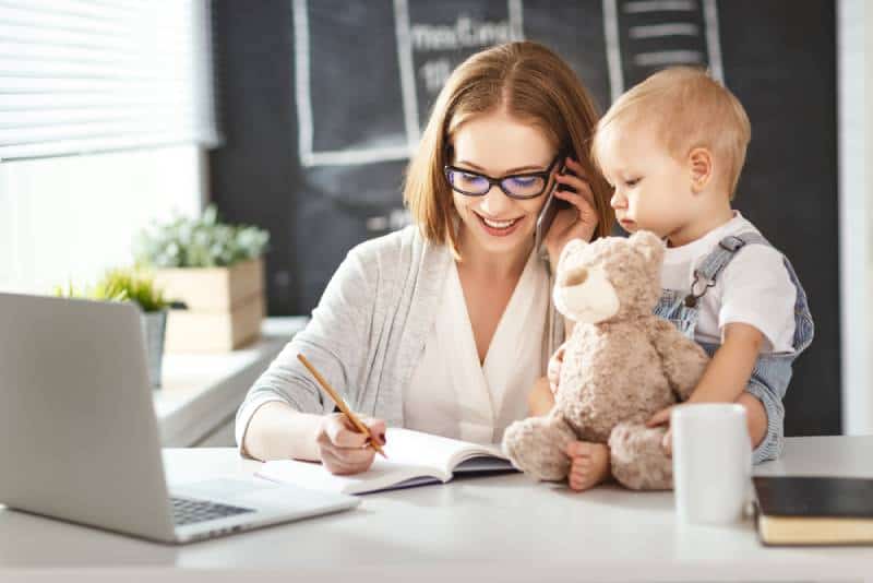 Mother with a toddler working at the computer