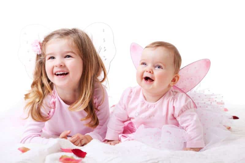 Little sisters wearing fairy wings