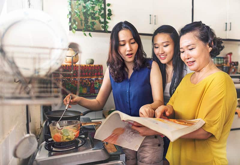 three women cooking with friends monthly meal plannera