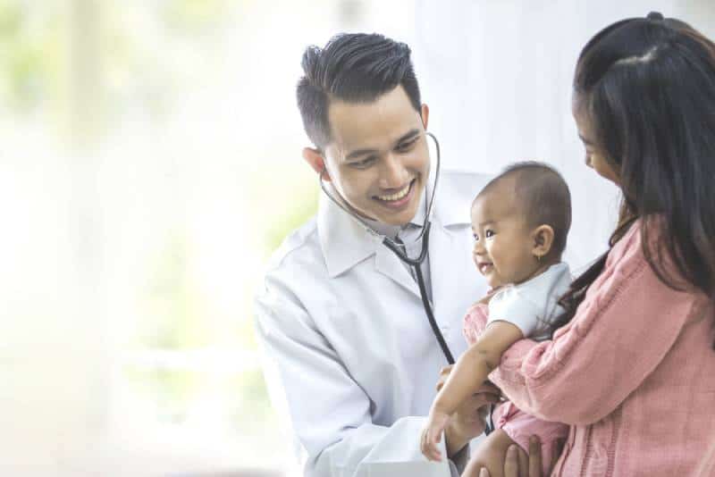 doctor checking baby using a stethoscope