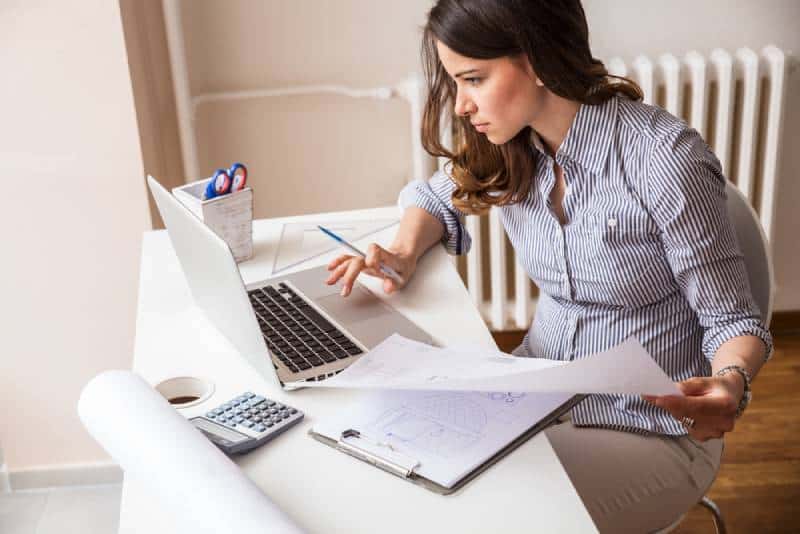 woman using laptop and working on her finances