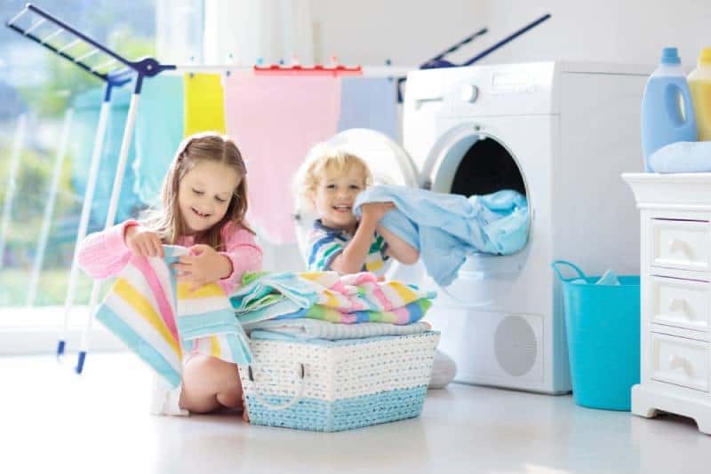 Children helping in laundry room