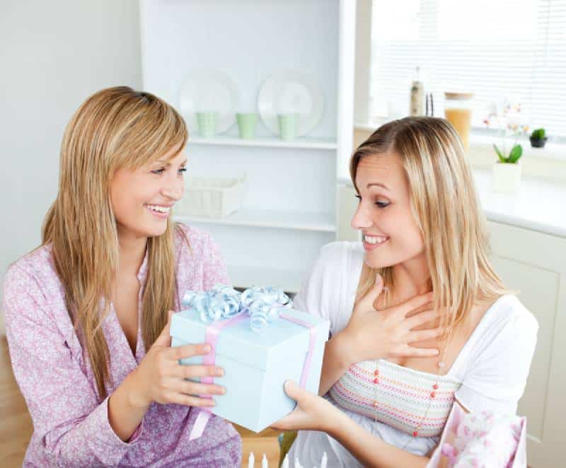 Sister giving a gift for sibling day