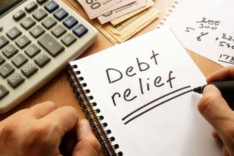 Note with words debt relief on a table