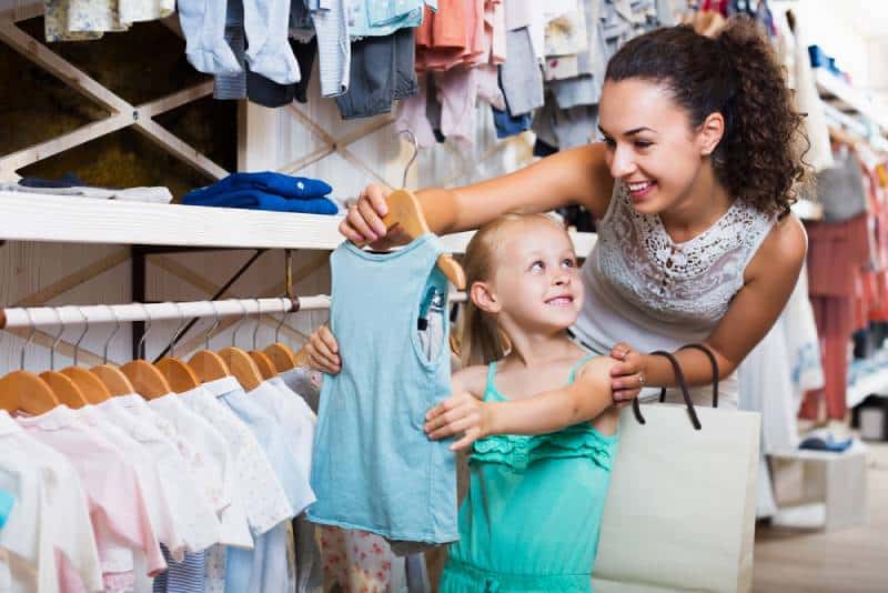 mother with daughter buying clothes