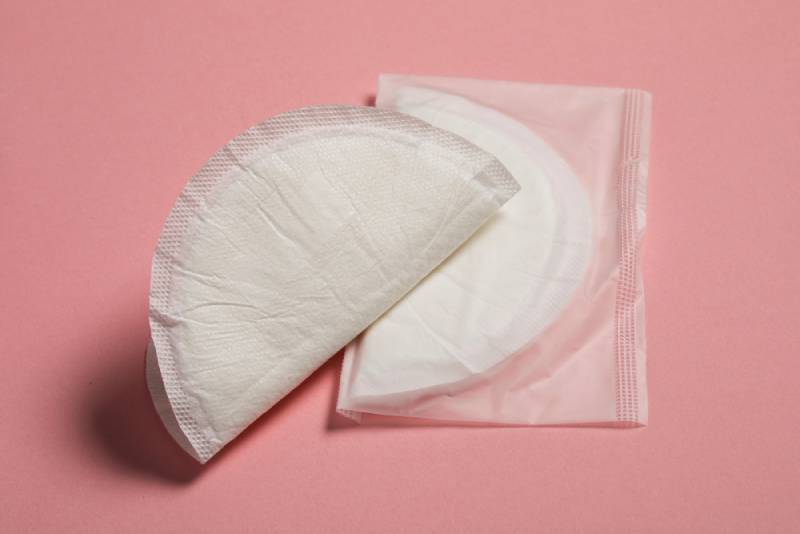 Round soft cotton breast pads on pink background