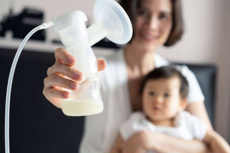 Mother holding breast pump 