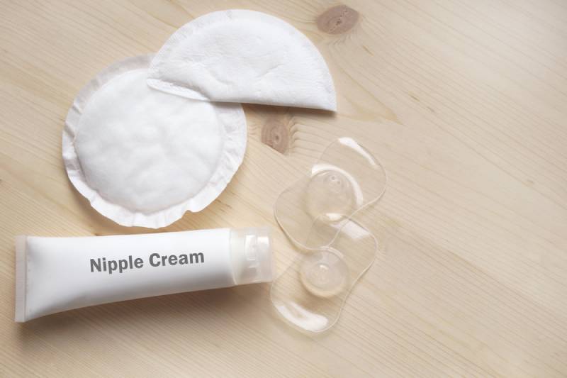 Nipple cream to make easier breastfeeding on a wooden table