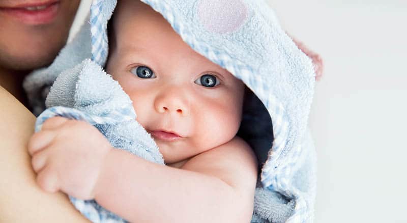 baby after shower covered in towel 