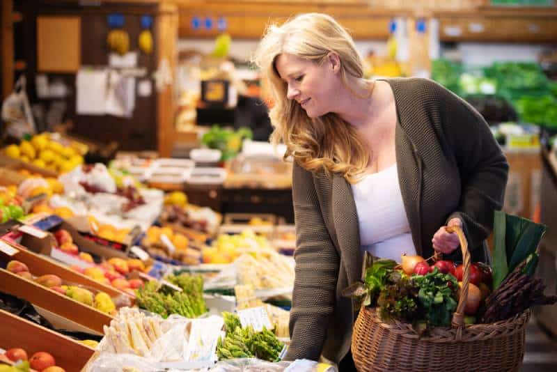 Woman is shopping fresh fruits and vegetables