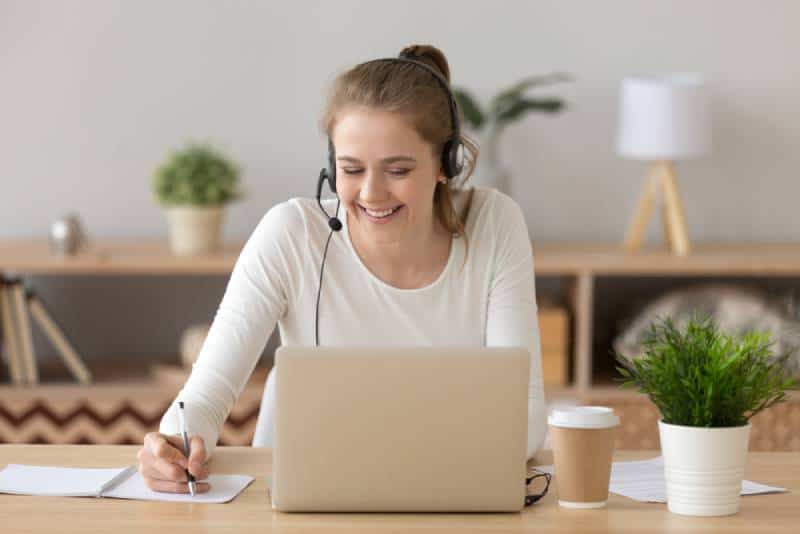 Woman with headset at home working as online teacher