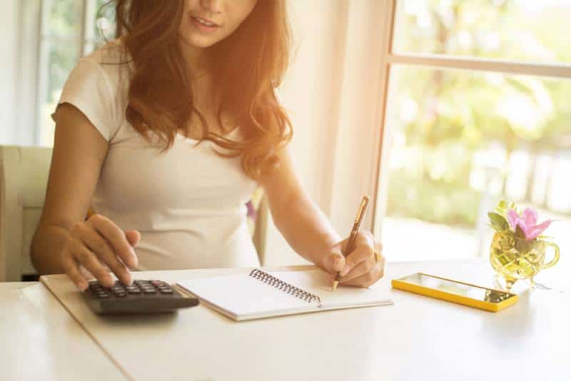 woman using the calculator and doing finances