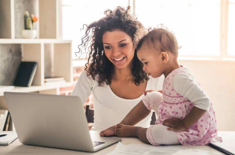 woman working and spending time with her child