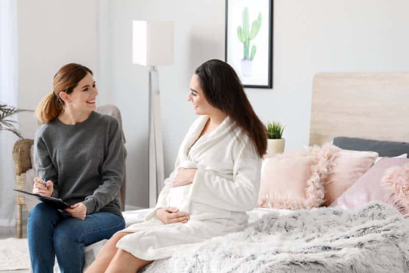 Doula talking to a pregnant woman in her room