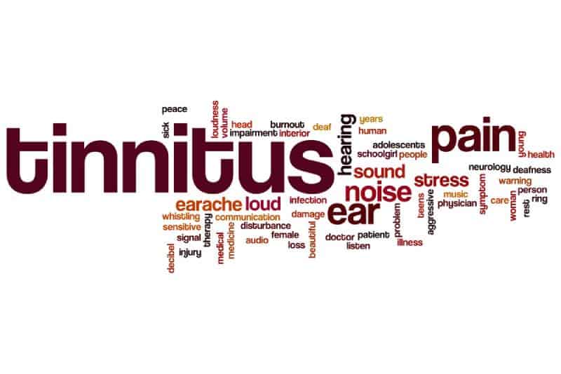 Tinnitus word written on white background with related disease symptoms