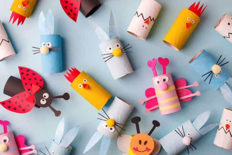 Colorful toilet paper roll crafts on blue background