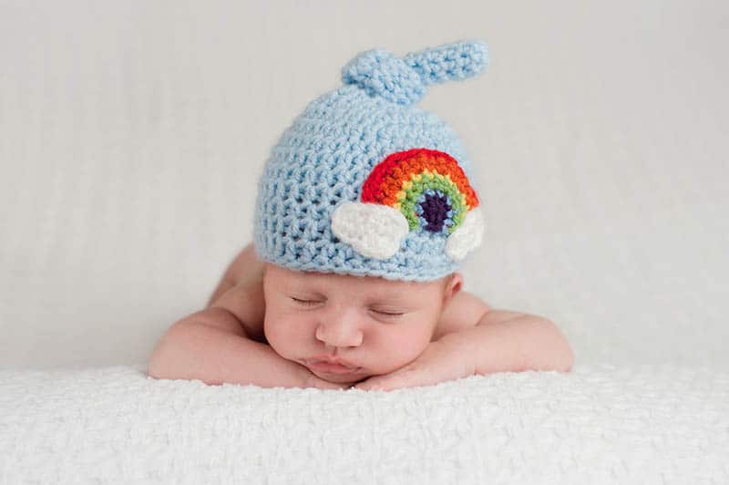 baby with blue cap 