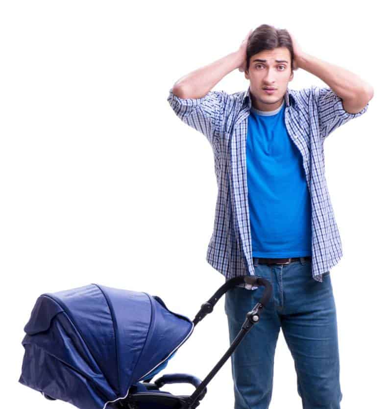 Confused dad with a baby in blue stroller on white background