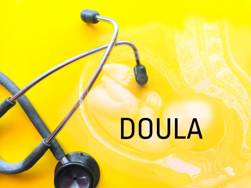 Stethoscope over yellow background written DOULA