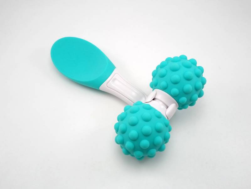 Portable blue manual lactation massager for mothers on white background