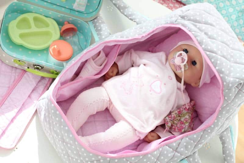 Baby doll with pink baby bag and carry bag