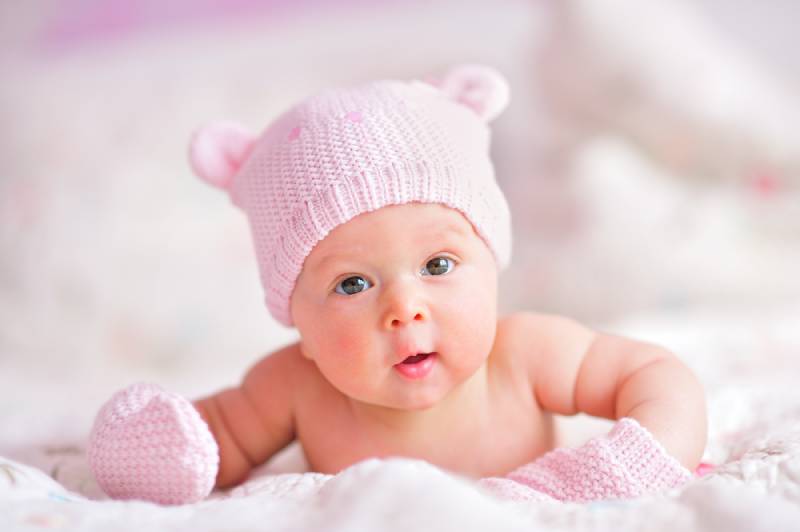 baby girl in a pink hat
