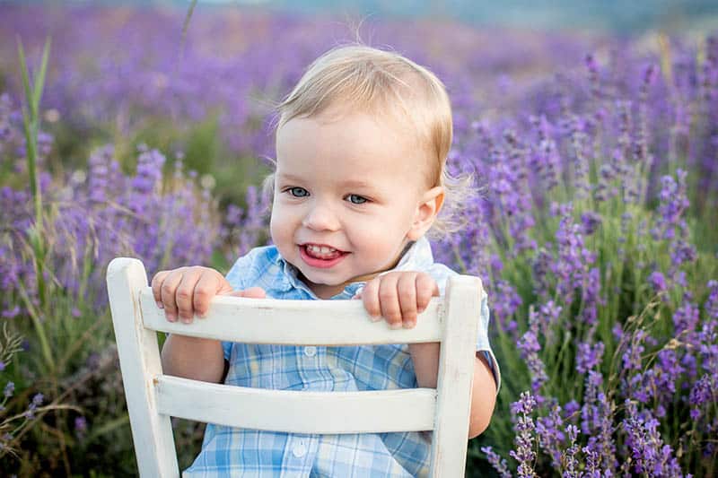 blonde boy toddler with french name in lavender summer field