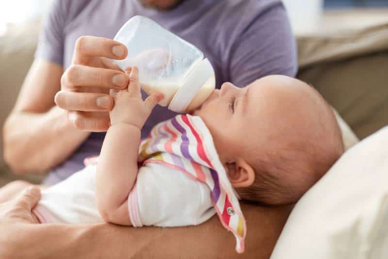mother bottle feeding baby