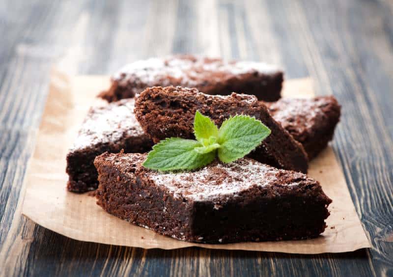Cake chocolate brownies with mint on wooden background
