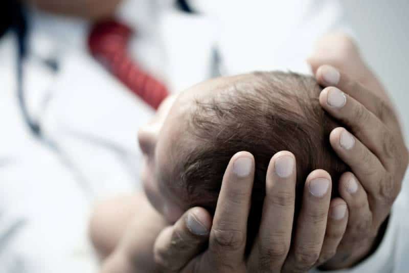 Doctor holding a newborn baby 