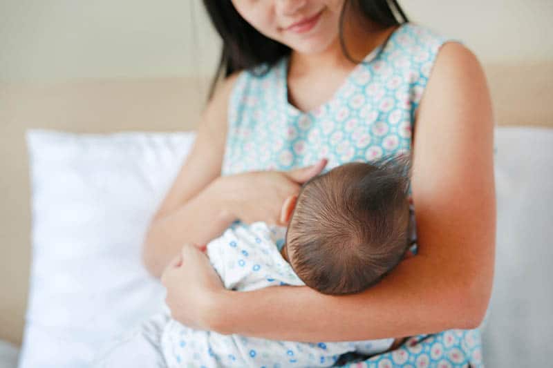 mother having oversupply of milk while breastfeeding