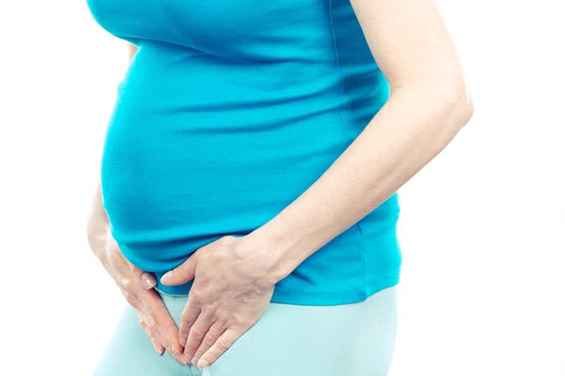 pregnant woman holding crotch having thrush
