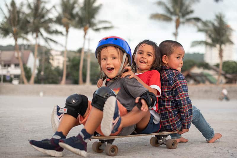 three kids on a skateboard