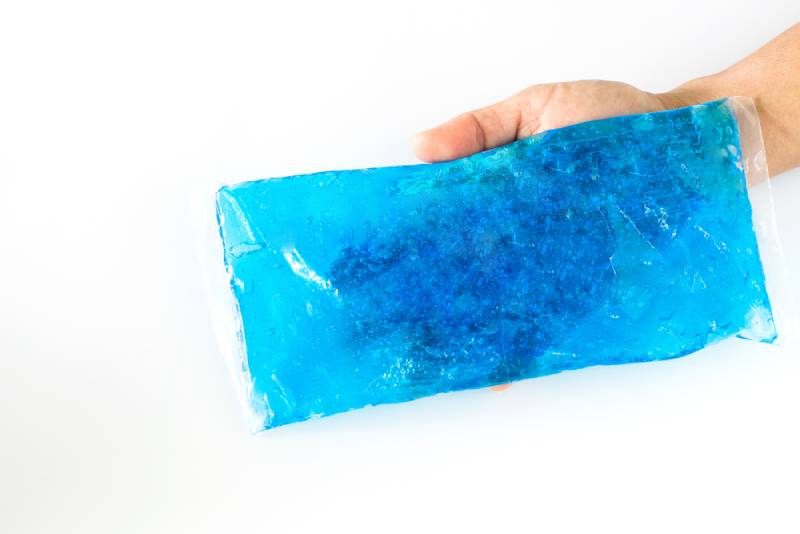 woman holding blue ice packs