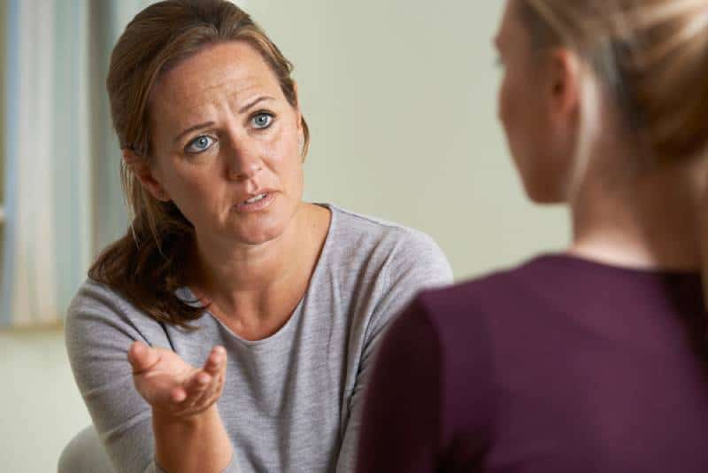 Mature woman talking to her daughter about a problem