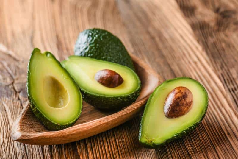 Avocado in a bowl on a wooden table