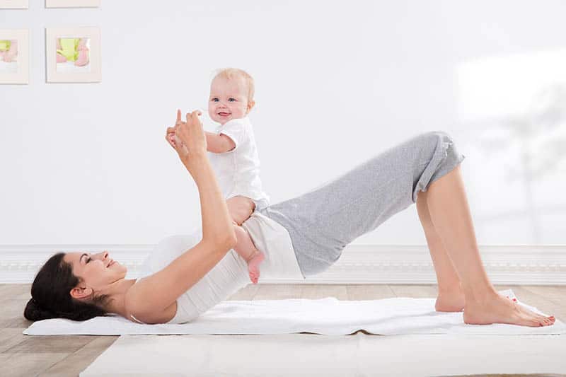 baby and mother doing yoga