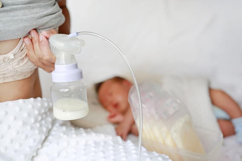 mother pumping breast milk for baby