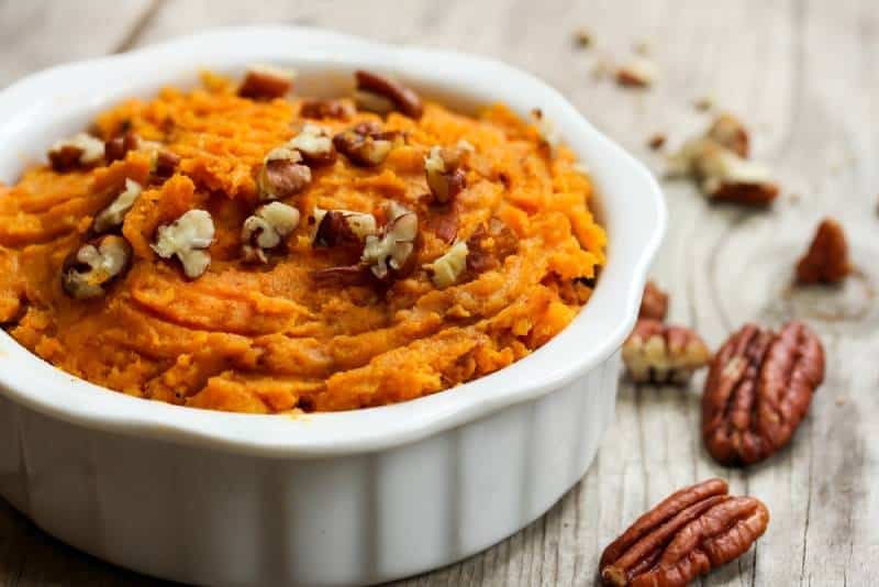 Mashed Sweet Potatoes with Pecans in a white bowl