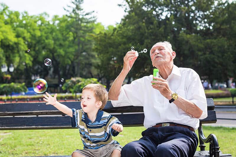 granddad with kid playing in park