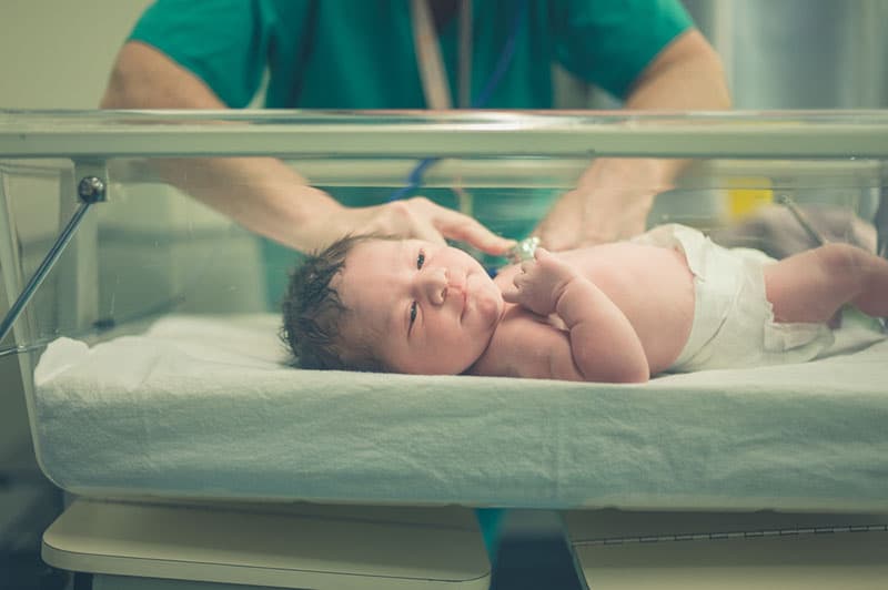 newborn baby lying in hospital