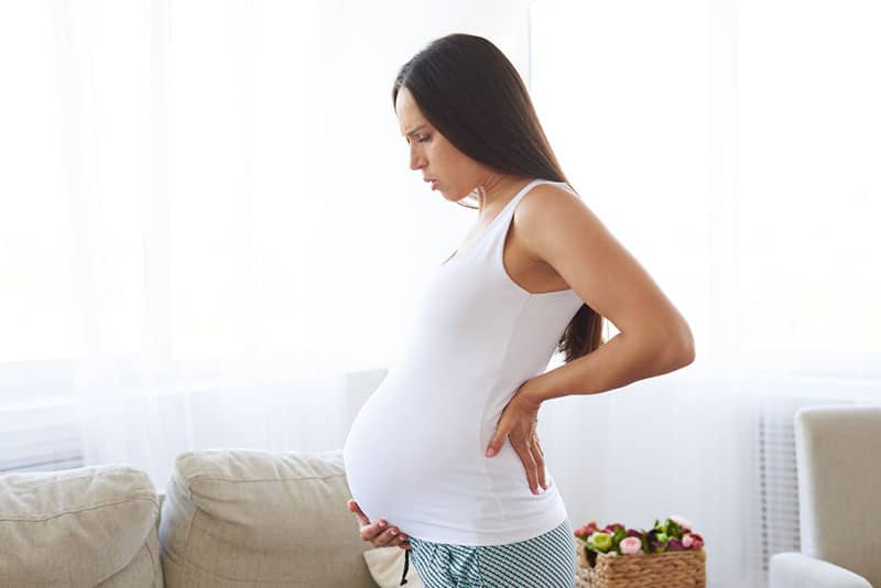 pregnant woman standing in the living room