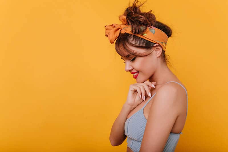 woman with hair accessories with orange background
